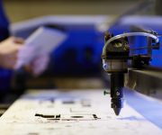 Laser cutting beam over plywood sheet